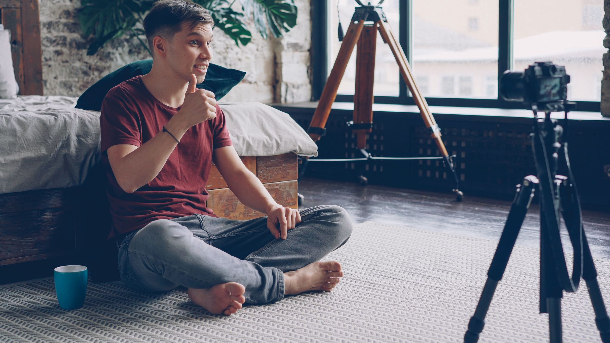 Home Young Man Sitting On The Floor Filming